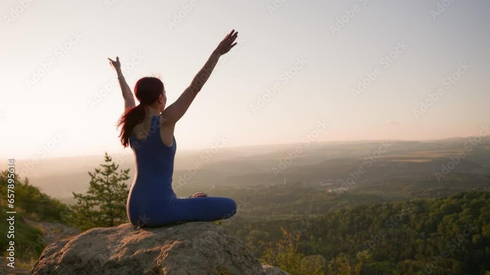 Athletic Woman Doing Yoga Poses on Top of a Mountain During Sunset. Sports Girl Trains and Does Stretching Exercises in the Mountains. Healthy Lifestyle, Zenism, Workout Concept. Slow Motion. Athletic Woman Doing Yoga Poses on Top of a Mountain During Sunset. Sports Girl Trains and Does Stretching Exercises in the Mountains. Healthy Lifestyle, Zenism, Workout Concept. Slow Motion.