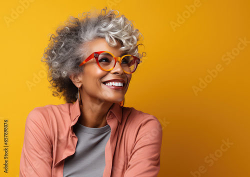 Generative AI, joyful dark-skinned elderly woman in casual stylish clothes smiling on color background, advanced age, old lady, empty space, mature people, happy pensioner, retired lifestyle