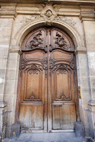 Old ornate door in Paris - typical old apartment buildiing.