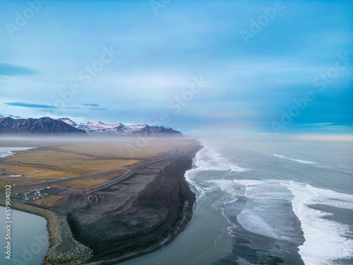 Atlanic shore black sand beach with massive waves crashing on icelandic coastline, majestic natural setting where ocean meets the beach in iceland. Aerial view of gorgeous landscape. photo