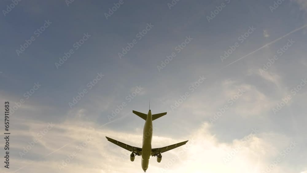 Jet plane landing in silhouette. Tracking shot of airplane landing. Modern business jet flying overhead. 4K Airplane impressive landing flying overhead. Jet plane landing in silhouette. Tracking shot of airplane landing. Modern business jet flying overhead. 4K Airplane impressive landing flying overhead.