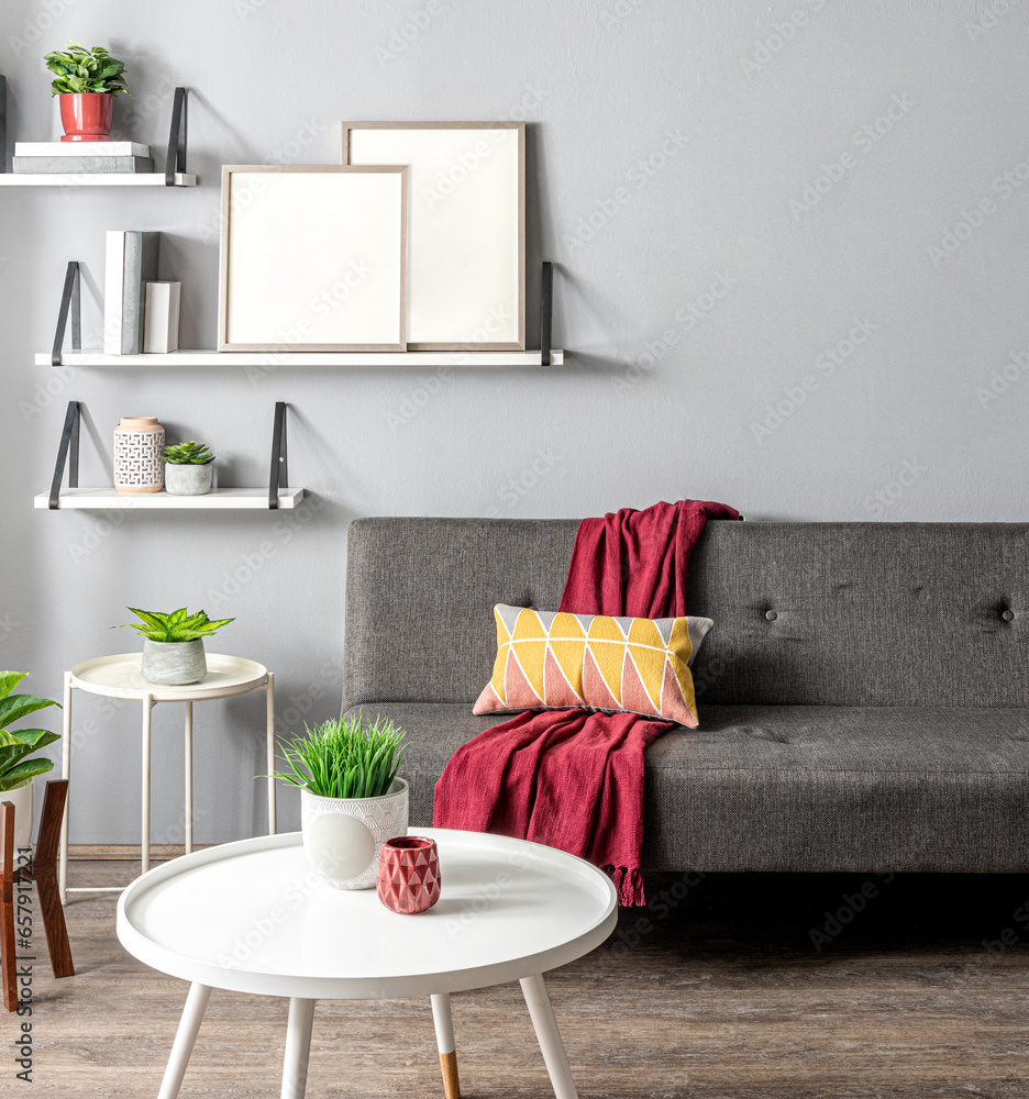 Living Room Interior Featuring Grey Armless Sofa, White Round Coffee Table with Wooden Legs, and