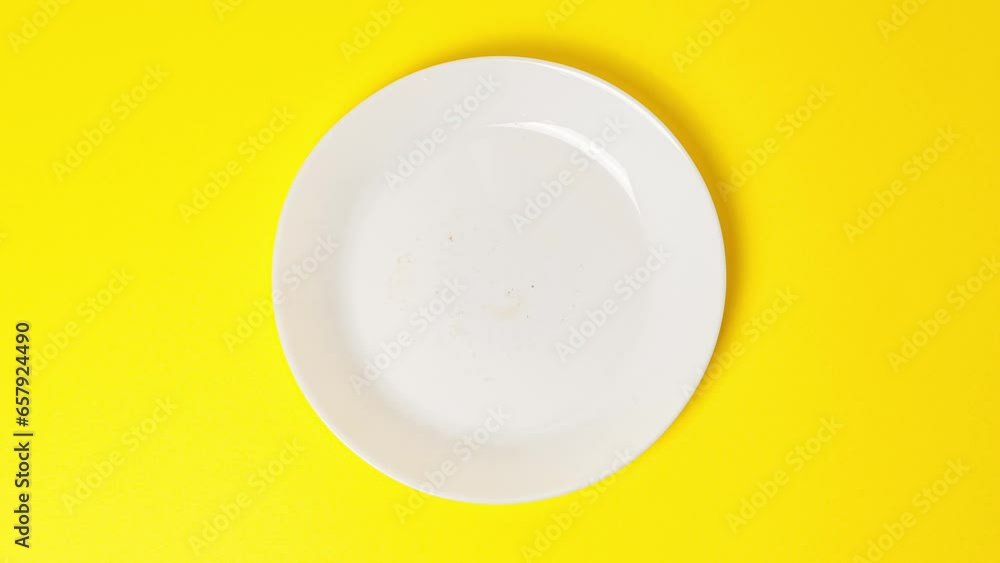 Eating delicious sweet donut covered with chocolate glaze on bright yellow background. Stop motion food donut animation video. Bakery and food concept. Top view of chocolate doughnut in 4K Eating delicious sweet donut covered with chocolate glaze on bright yellow background. Stop motion food donut animation video. Bakery and food concept. Top view of chocolate doughnut in 4K