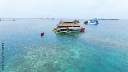 Group of houses floating in the sea on Tintipan Island in the San Bernardo Archipelago, Colombia. photo