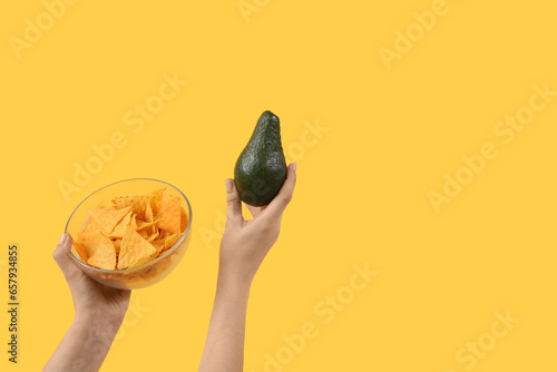 Female hands holding nachos...