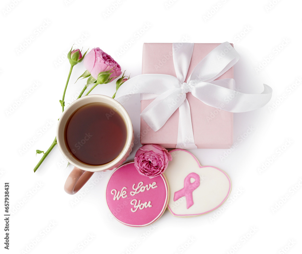 Cookies with text WE LOVE YOU, pink ribbon, rose flower, gift box and cup of tea isolated on white background. Breast cancer awareness concept