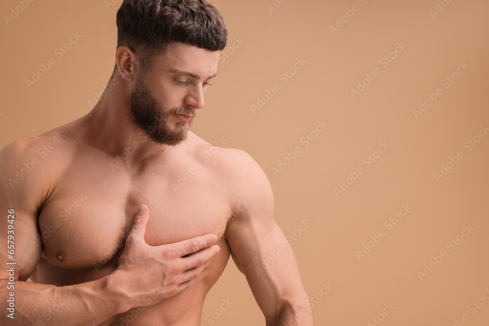 Handsome muscular man on beige background, space for text. Sexy body Handsome muscular man on beige background, space for text. Sexy body