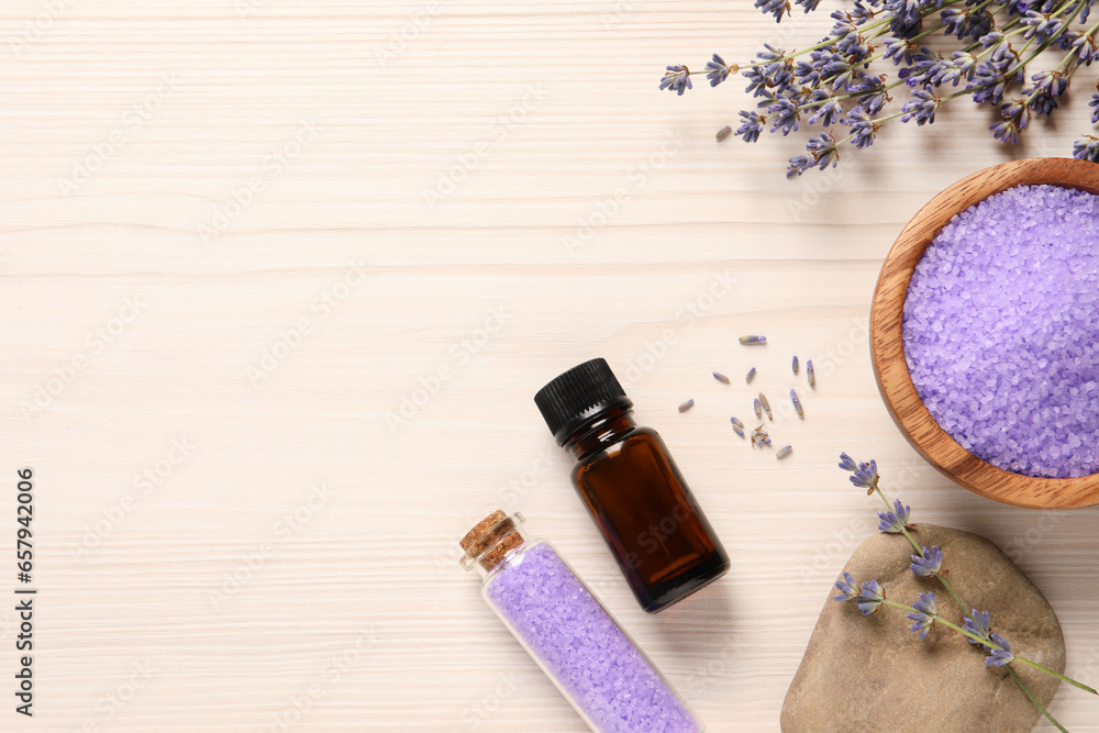 Bowl of sea salt, essential oil and lavender flowers on white wooden table, flat lay. Space for text Bowl of sea salt, essential oil and lavender flowers on white wooden table, flat lay. Space for text