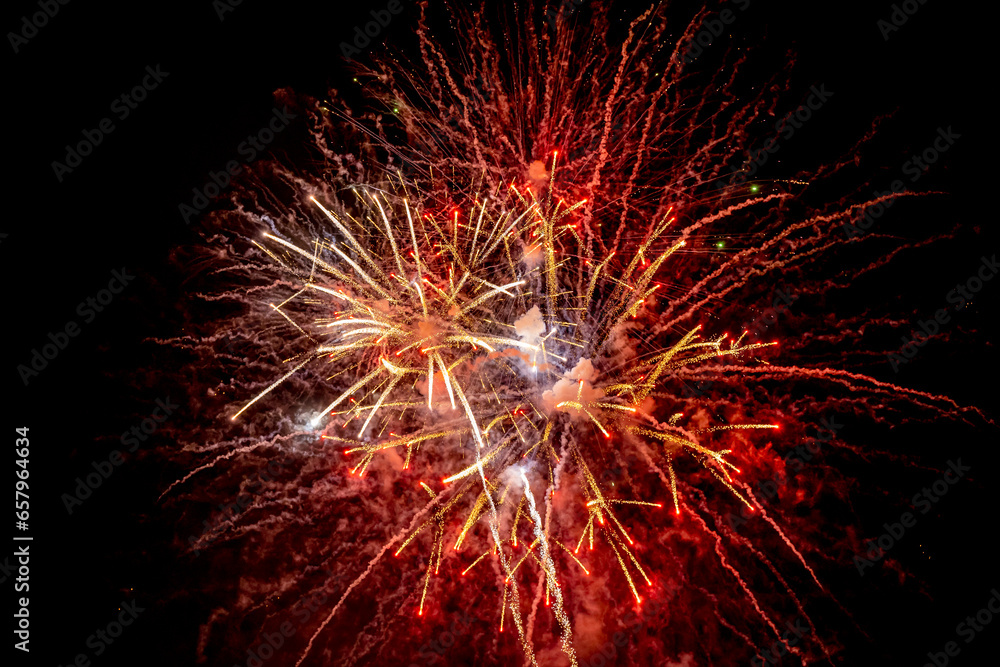Holiday fireworks explode in the night sky. Selective focus. Holiday fireworks explode in the night sky. Selective focus.