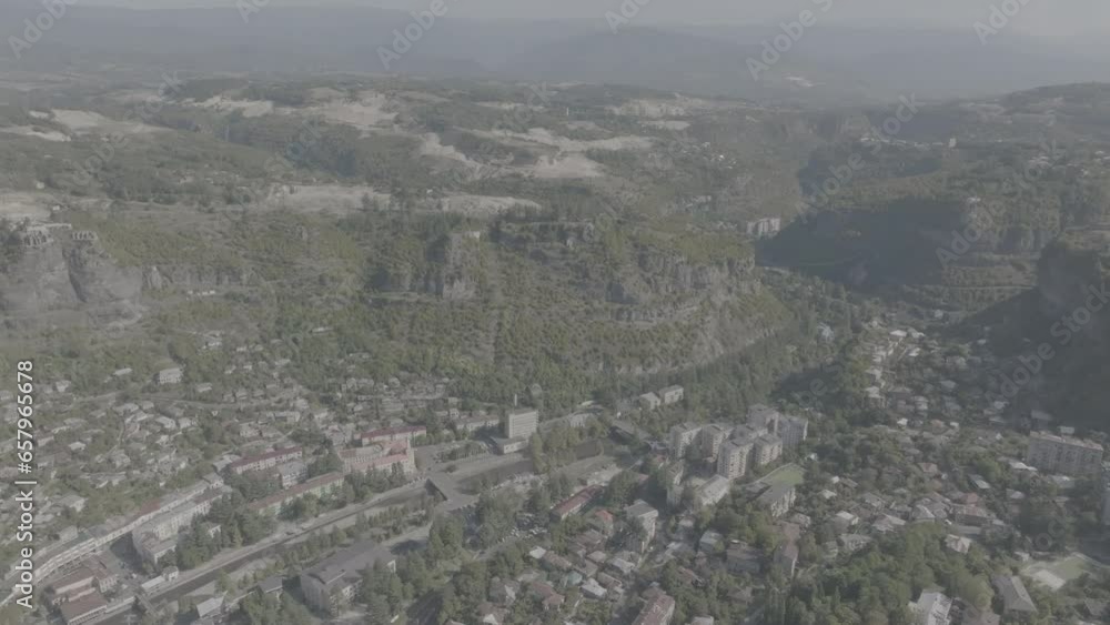Aerial view of the Chiatura miners city in Imereti province, Georgia. Drone footage of the Chiatura cityscape in summer. Ungraded D-Log Aerial view of the Chiatura miners city in Imereti province, Georgia. Drone footage of the Chiatura cityscape in summer. Ungraded D-Log