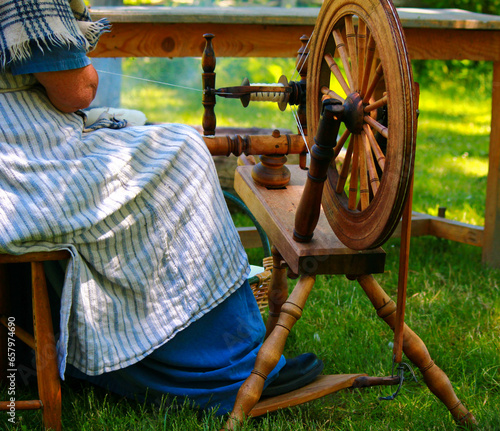 old countrywoman and her spinning-wheel photo