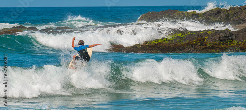 Canvas Print Surfing in the waves of Los Cerritos beach, in Todos Santos Mexico