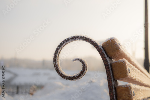 A fragment of a bench in a winter park