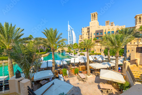 The canal, cafes and shops of the Souk Madinat Jumeirah, an upscale shopping market and mall in Dubai, United Arab Emirates photo