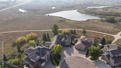 Aerial footage of Briarwood, Saskatoon, SK, highlighting its elegant homes, winding streets, and green parks. A tranquil suburban escape, perfect for real estate visuals. photo