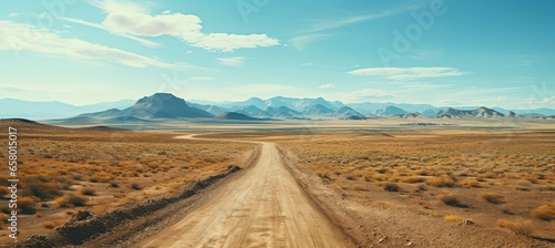 Rural dirt road at desert with rocky mountains background. Generative AI technology. 