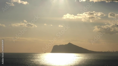 Calpe Spain late evening sunshine from Pena De Ifac with the skyline of Benidorm in the distance photo