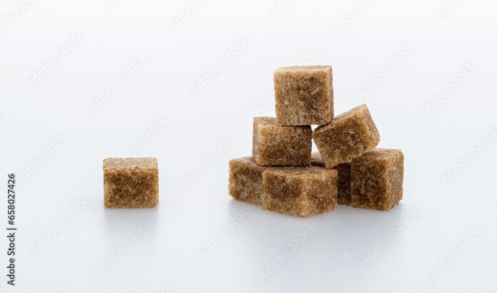 pile of brown sugar cube on white background pile of brown sugar cube on white background