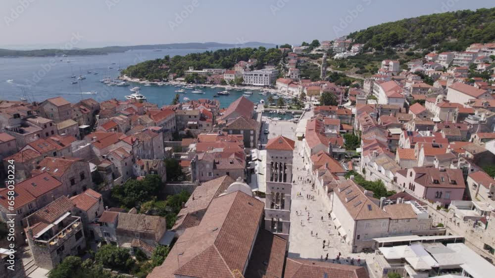 Historic square of St. Stephen near the port in Hvar in Croatia. Aerial pan Historic square of St. Stephen near the port in Hvar in Croatia. Aerial pan
