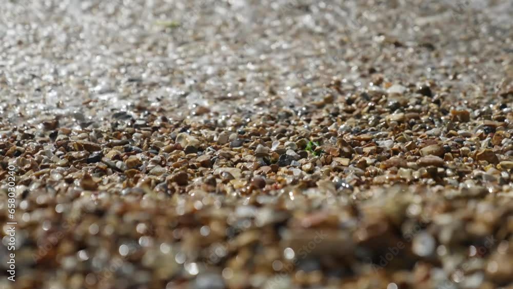 Close up of waves splashing against pebbles on the beach. Slow motion shot, 1080p. Close up of waves splashing against pebbles on the beach. Slow motion shot, 1080p.