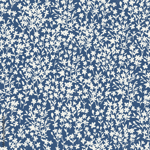 Seamless floral pattern for design. Small white flowers. Blue background. Modern floral texture. An elegant template for fashionable prints.
