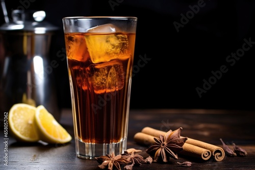 a thermal glass of hot herbal tea next to a cold cola drink