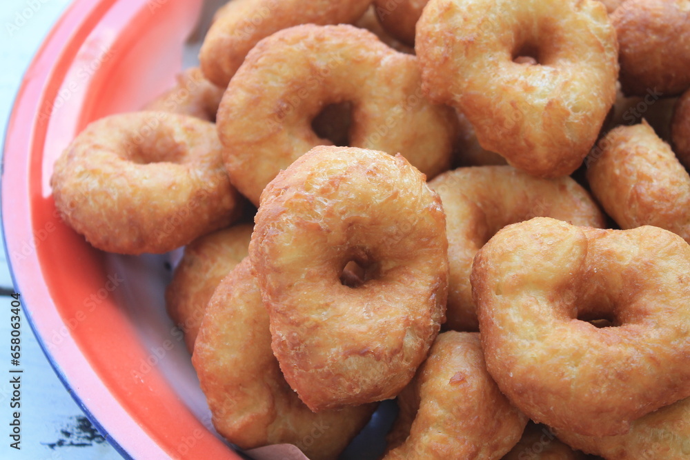 Stack of donuts in tray on table Stack of donuts in tray on table