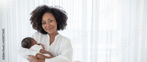 Close up portrait of beautiful young African American  mother holding sleep newborn baby in hospital bed room. Healthcare medical love black afro woman lifestyle mother's day, breast copy space banner