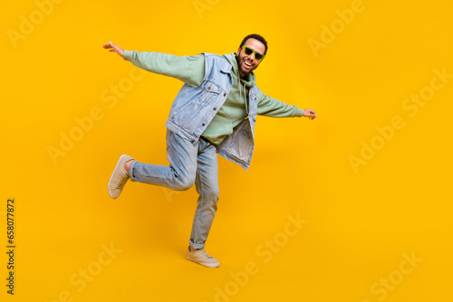 Full length size body cadre freedom careless guy hipster style youth denim style outfit dancing isolated on bright yellow color background