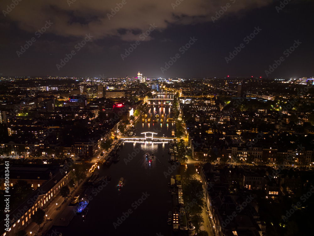 Beautiful evening Amsterdam aerial view from above with narrow canals and old famous architecture.