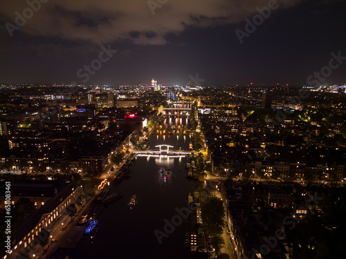 Beautiful evening Amsterdam aerial view from above with narrow canals and old famous architecture.