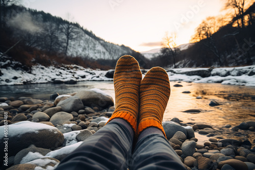 Thermal socks hanging outside a camping tent in a winter landscape, essential for keeping feet warm during outdoor activities photo