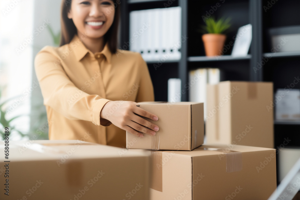 Closeup hand of business woman owner happy with shipping package at home office packaging box on background.ecommerce logistics,Online sale. Closeup hand of business woman owner happy with shipping package at home office packaging box on background.ecommerce logistics,Online sale.