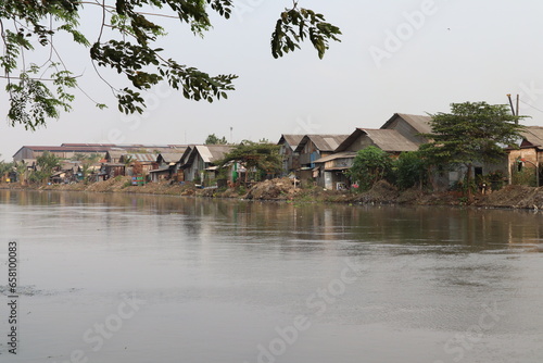 Inspeksi Kali Malang, Cikarang, Bekasi, Indonesia - September 22 2023: Slum houses on river banks are very vulnerable to flooding and dirty water