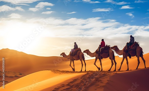 Camel caravan with people going through the sand dunes in the Desert
