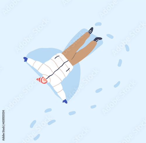 Man making snow angel, lying in snowdrift, aerial top view. Winter holiday fu...