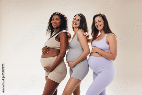 Pregnant women enjoying a supportive yoga class for a healthy and happy third trimester photo