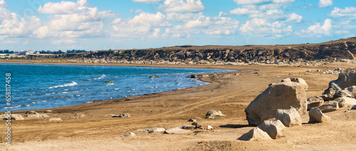 Panoramic view of empty sandy beach and blue sea photo