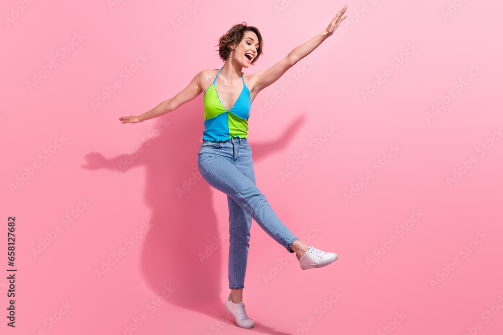 Full length cadre of carefree drunk young lady dance boogie woogie hands wings positive rhythm clubbing isolated on pink color background Full length cadre of carefree drunk young lady dance boogie woogie hands wings positive rhythm clubbing isolated on pink color background