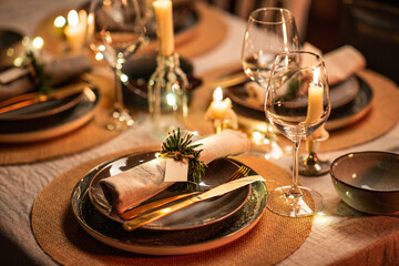 winter holidays, dinner party and celebration concept - close up of scandinavian christmas table serving with burning candles at home at night