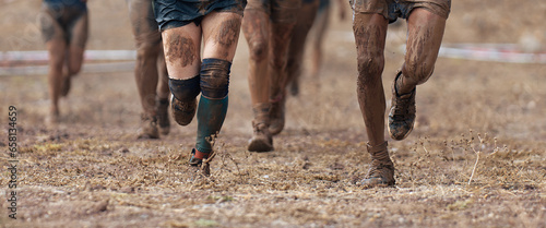 Fotografie Group of participants in an obstacle course race running