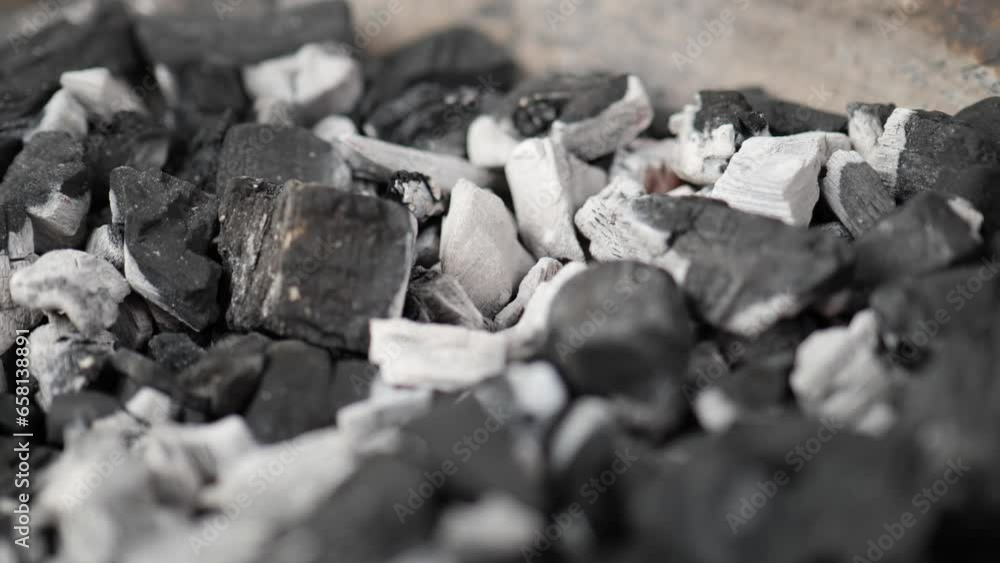 white glowing charcoal in grill bowl close up white glowing charcoal in grill bowl close up