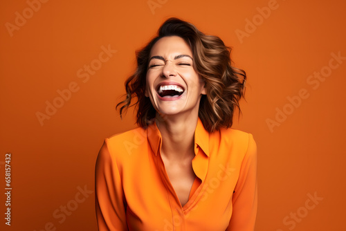 happy 40 years old businesswoman, who is smiling and laughing, wearing bright clothes. orange background, studio photos. created by generative technology.