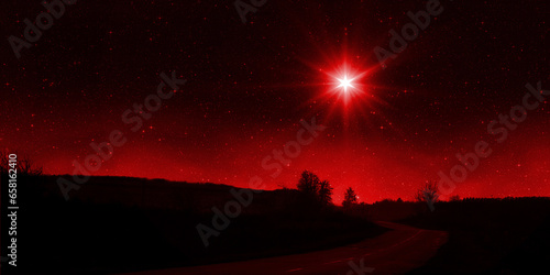 Bright red star shines over the road at night. Birth of Jesus concept  Star of Bethlehem
