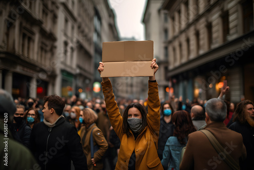 Woman in the streets protesting, holding a sign © fraudiana