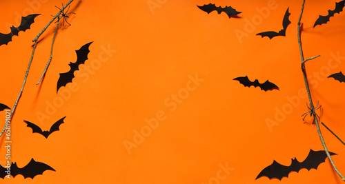 Eerie Halloween Banner: Bats, Tree Branches, and Spiders on an Orange Background