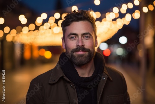 Portrait of a handsome bearded man on the street at night.