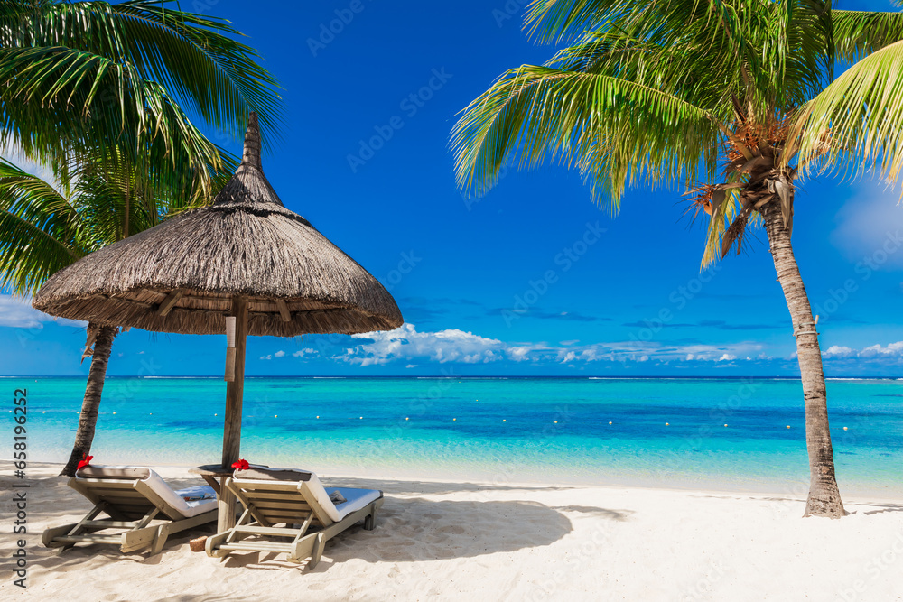 Chairs and umbrella at coconut palm beach. Tropical holiday banner with ocean in Mauritius