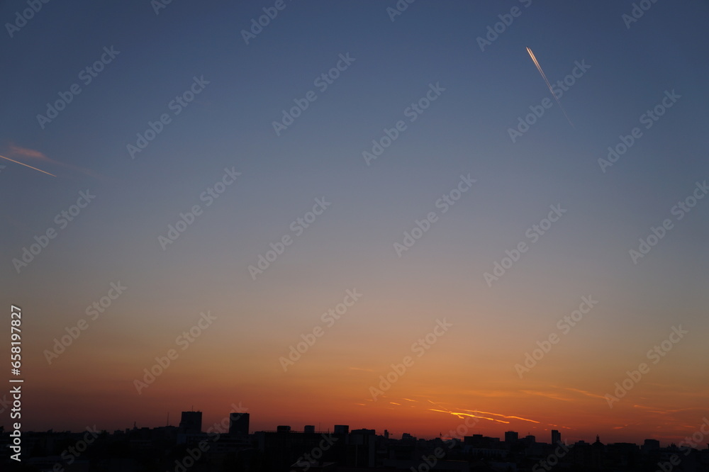 Bucharest skyline at sunset, sunrise sky with clouds. Purple sunset over Bucharest city Bucharest skyline at sunset, sunrise sky with clouds. Purple sunset over Bucharest city