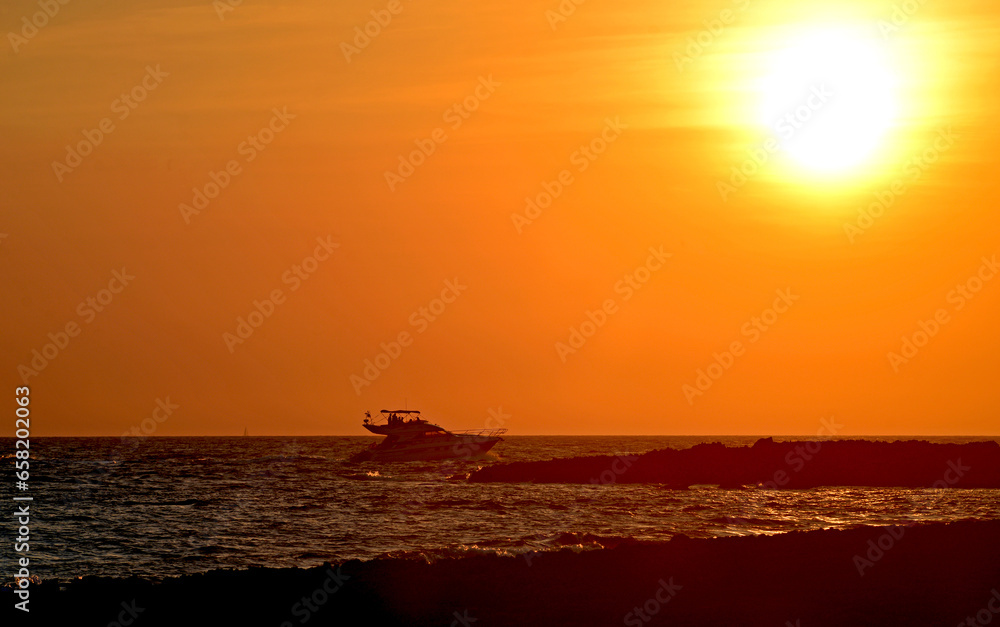 Motor yacht at sunset